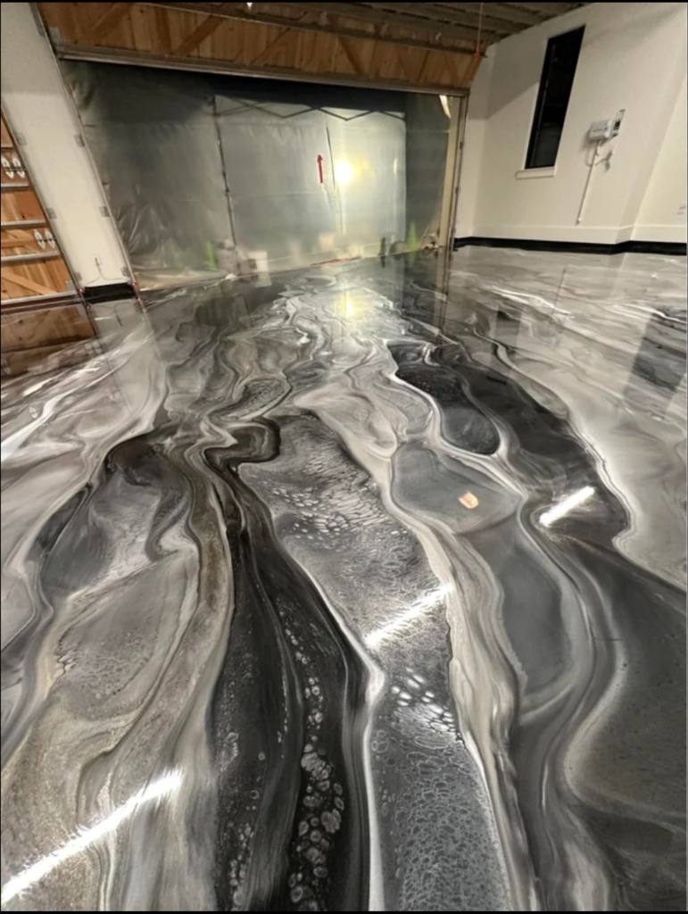 Silver and black metallic epoxy floor in a shop with the door open